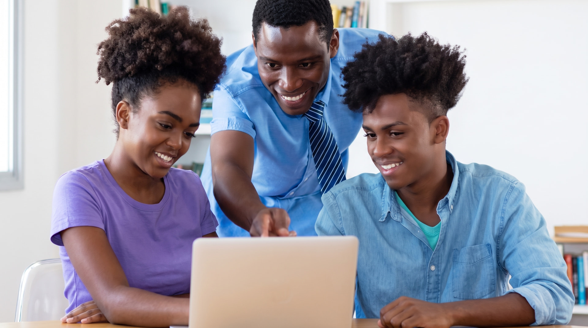 A-Global students learning together around a laptop